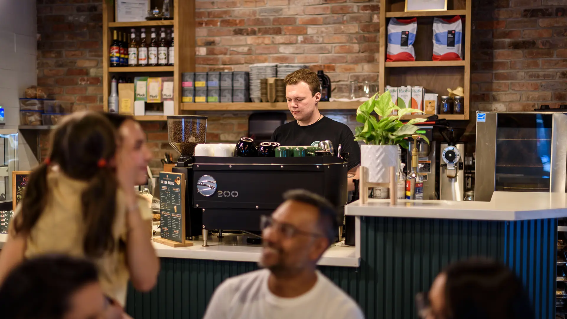 Barista preparing coffee at The Rosemount Café in Toronto, a coffee shop with patio on Weston Road.