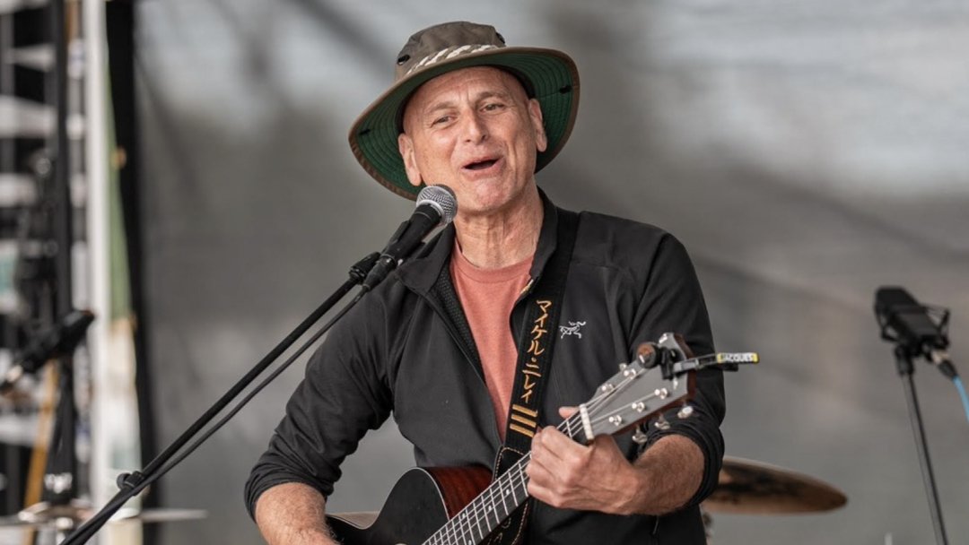 Michael Neray singing and playing guitar during a live jazz performance at The Rosemount Cafe in Toronto.