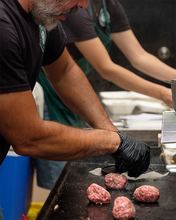 Smash burgers being cooked for the 2-year anniversary celebration at The Rosemount Cafe, a Toronto live music cafe and event space.