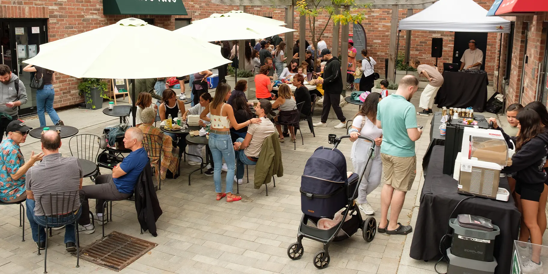 Guests seated, eating, and mingling on the coffee shop patio during an event at The Rosemount Cafe.