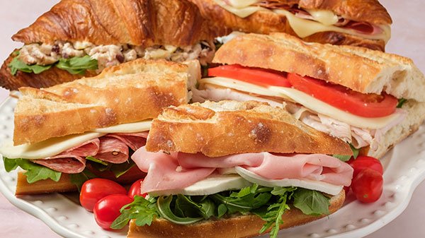 Half-sandwiches with assorted fillings including turkey pesto and grilled varieties for sandwich catering in Toronto.