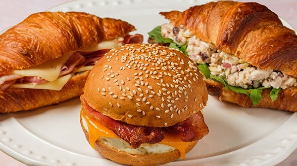 Breakfast sandwiches with assorted fillings, including ham and Swiss, bacon, egg and cheese, and chicken salad, for catering in Toronto.