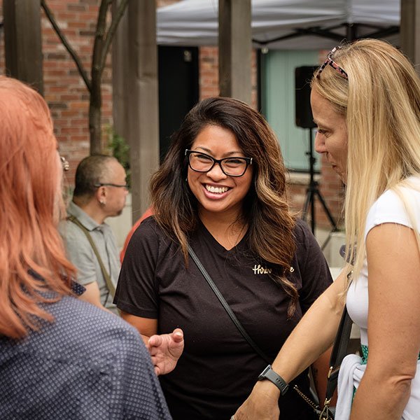 Guests enjoying conversations at The Rosemount Cafe anniversary party, a coffee shop with patio in Toronto.